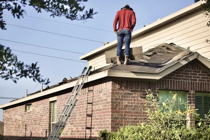 Professional roofer working on a residential roof in Fiddlers Green
